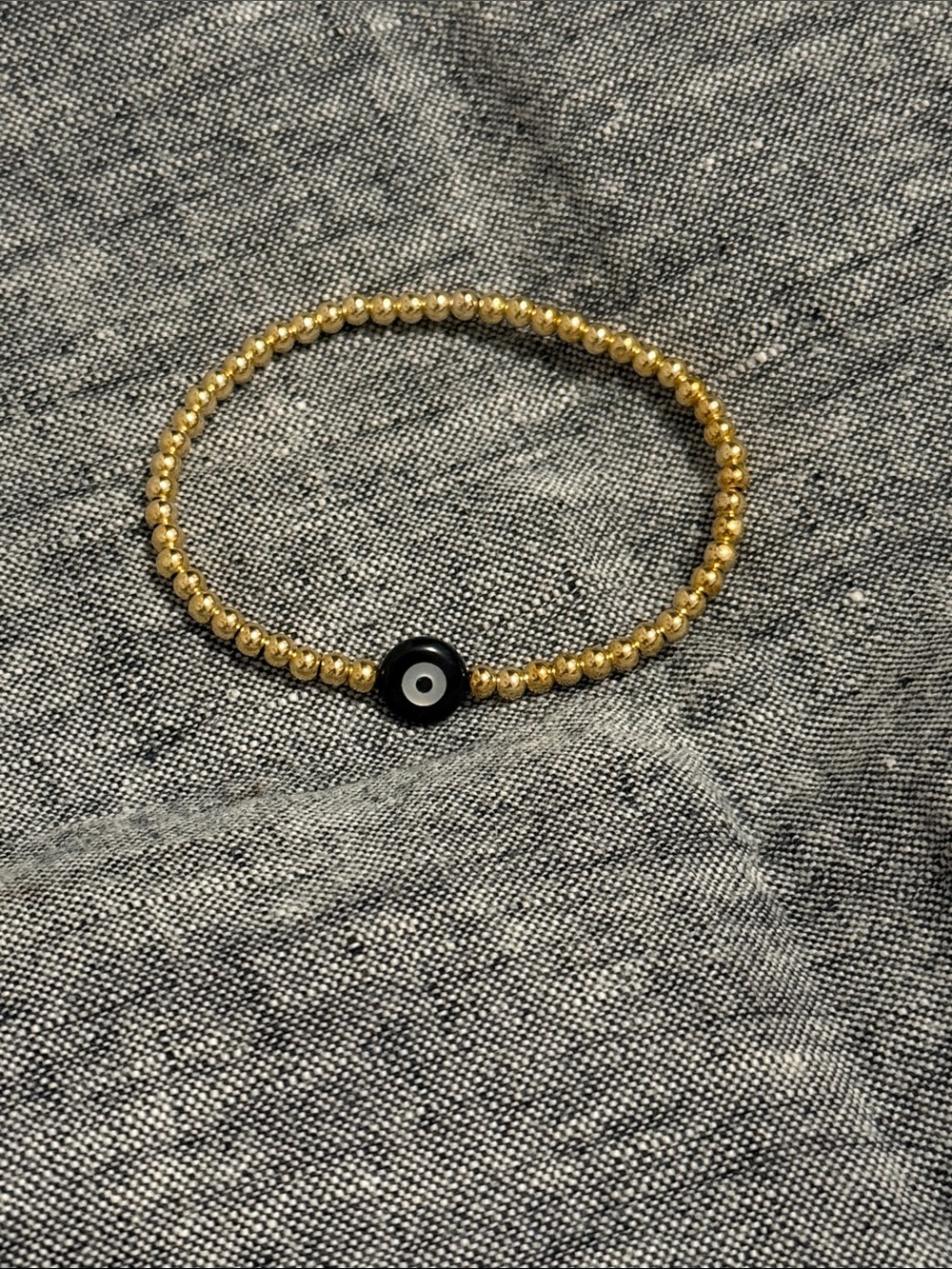 Gold Beaded Bracelet with Black Evil Eye Charm